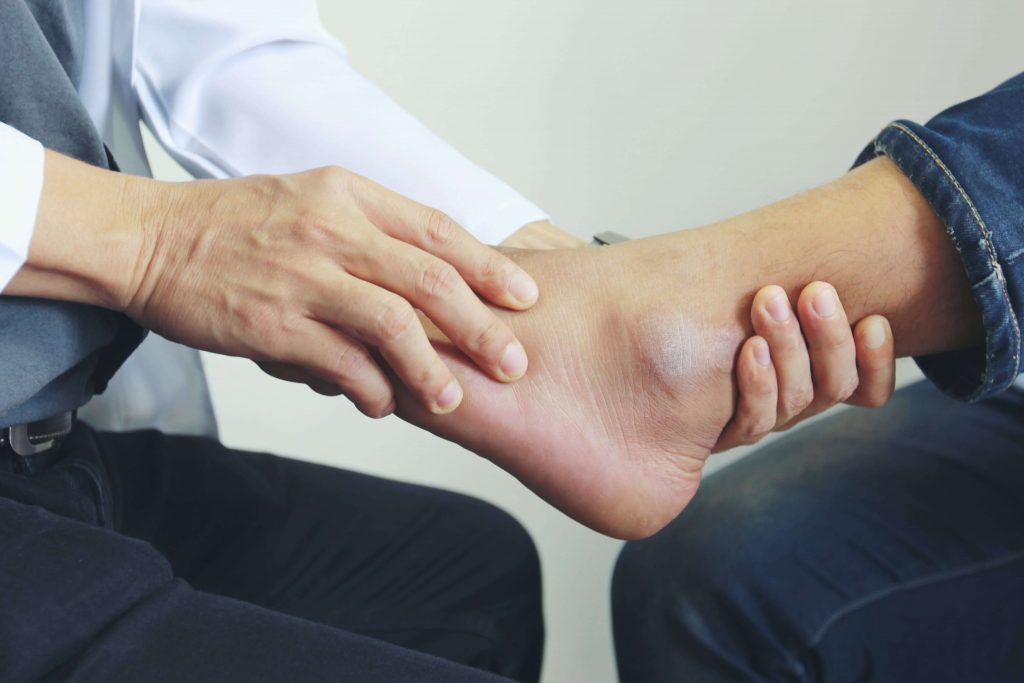 man in physical therapy after having ankle surgery
