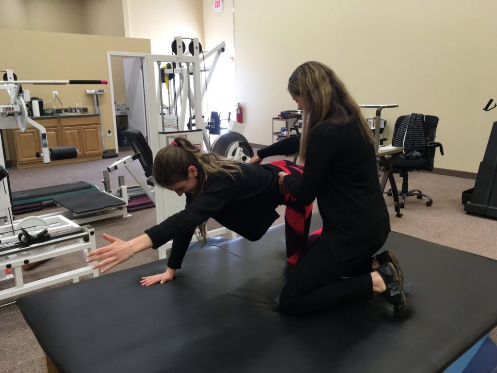 woman doing exercises with physical therapist