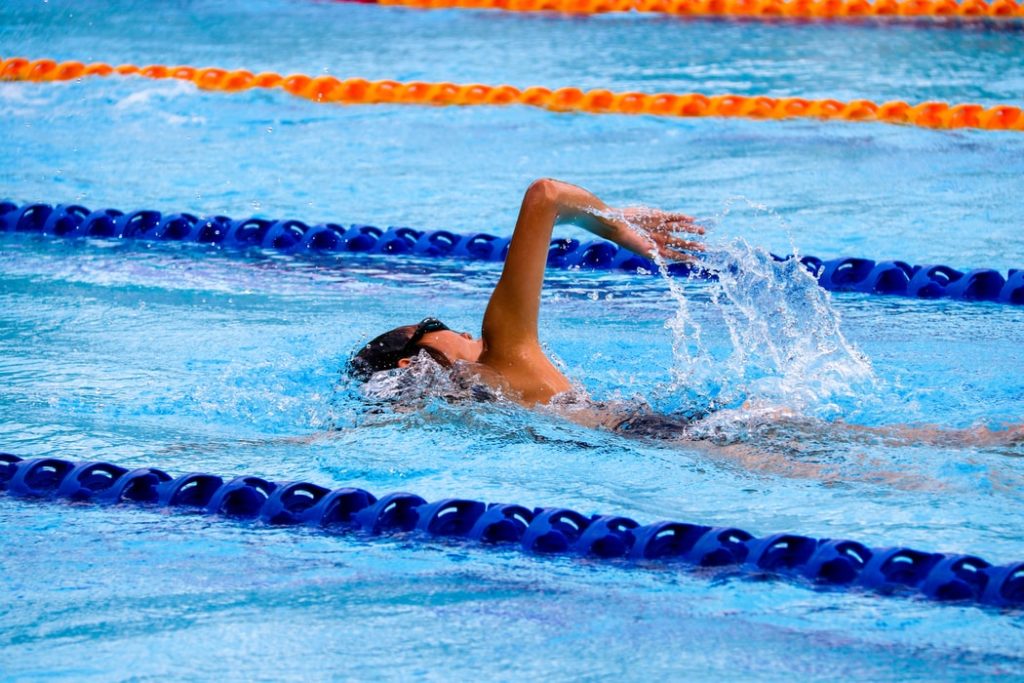 swimmer exercising shoulder in water