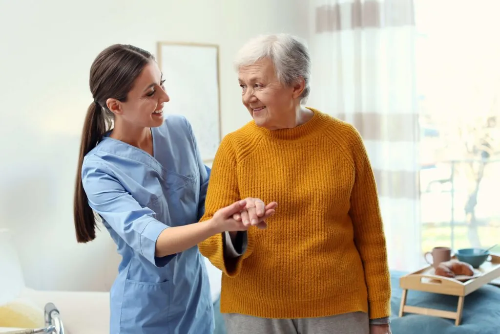 physical therapist helping elderly woman with fall prevention