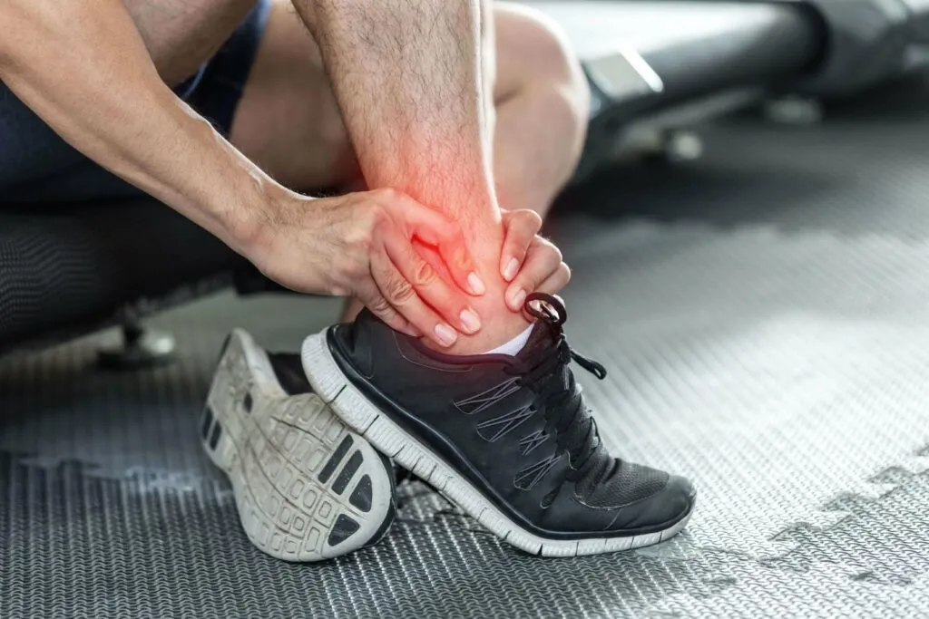 athletic man with ankle injury