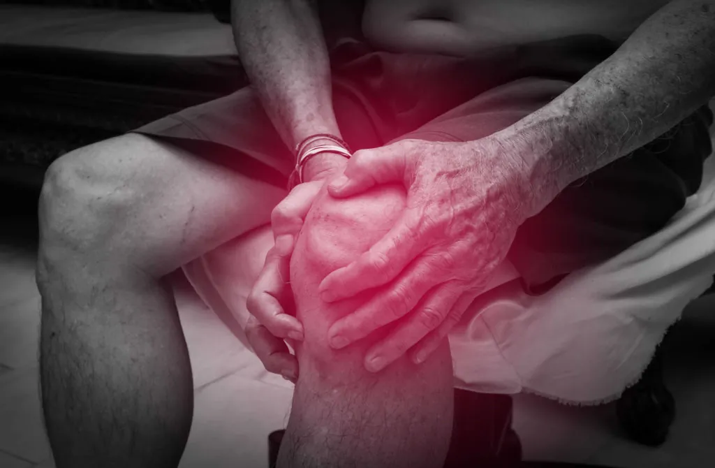 man suffering from knee pain after replacement surgery