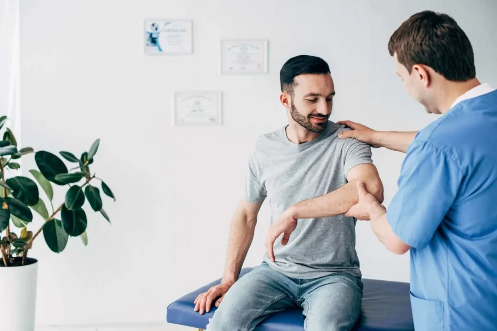 man in physical therapy after rotator cuff surgery