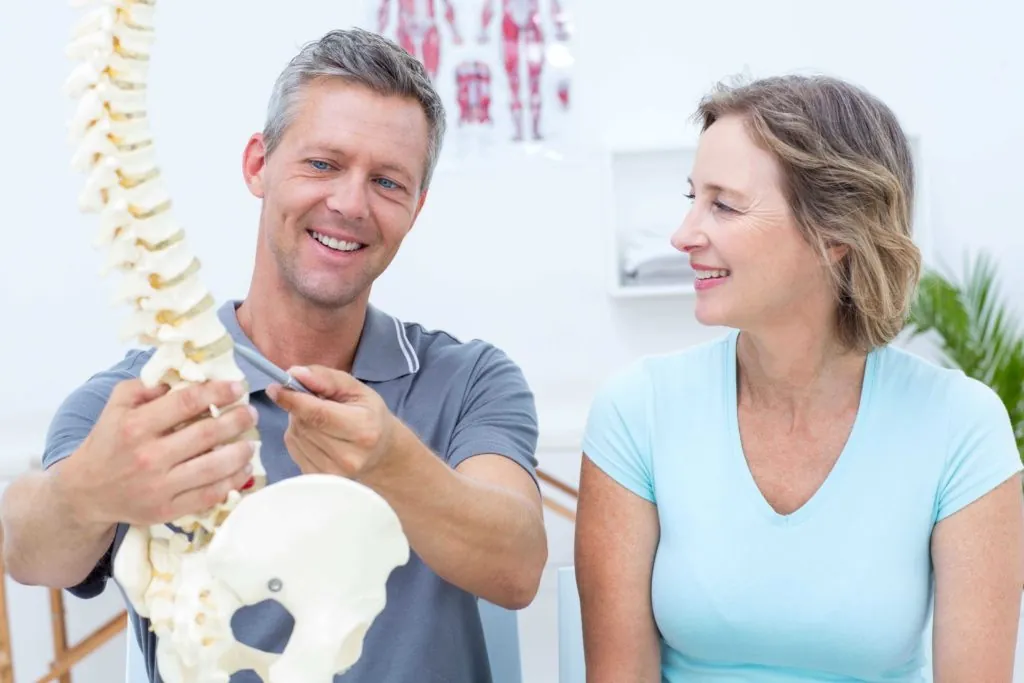 physical therapist explaining the schroth method for scoliosis